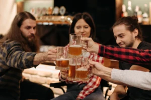 A group of friends clinking glasses filled with craft beer