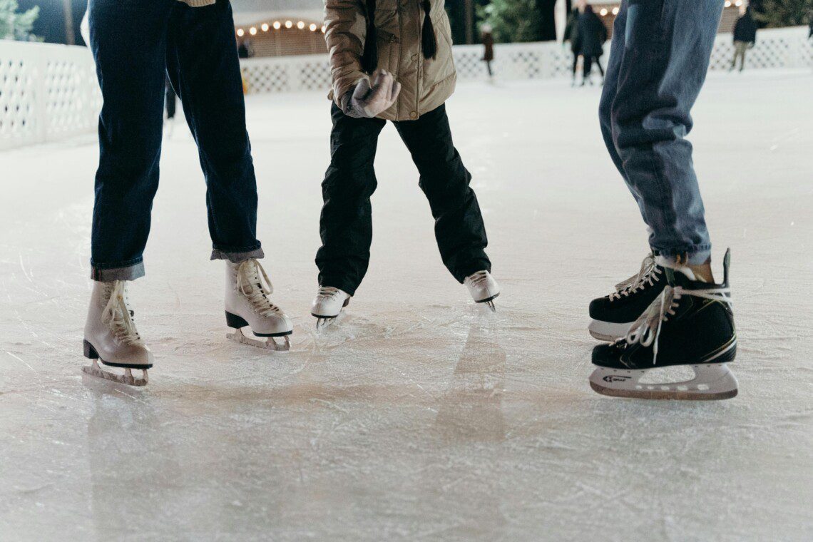 Family ice skating at The Woodlands Ice Rink near Spring, TX during the holiday season