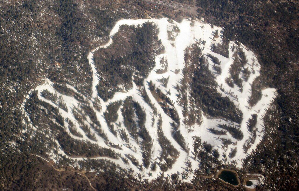Snow Summit Ski Resort aerial view with snow-covered ski runs and trails in Big Bear Lake California