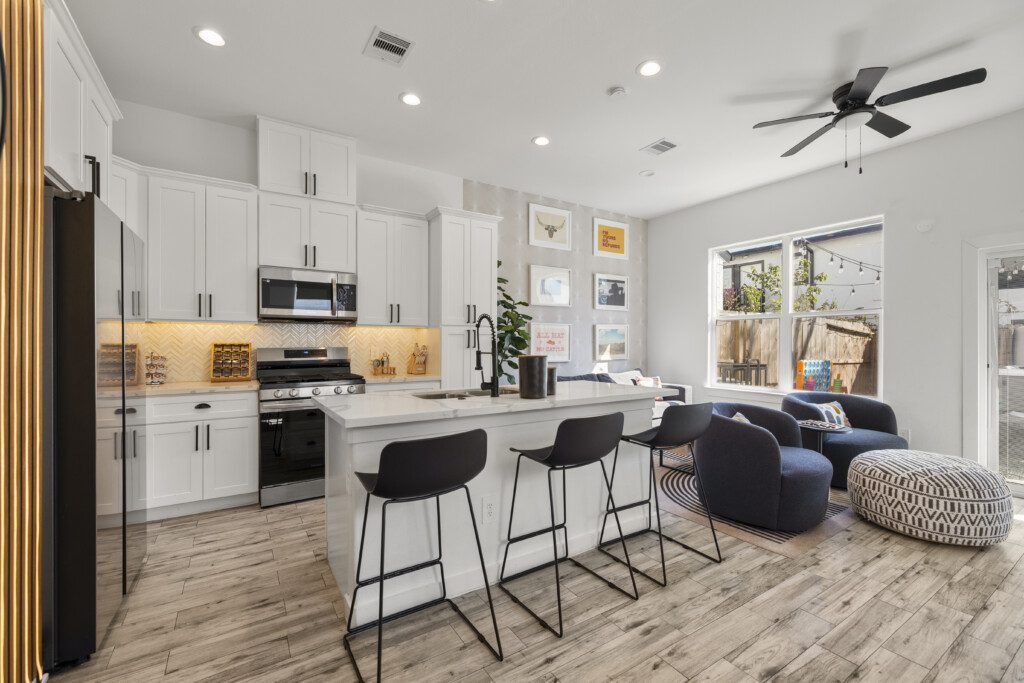 Sweeping open-concept main floor view with kitchen, living room, and backyard access at The Landing Pad Houston vacation rental near NRG Stadium