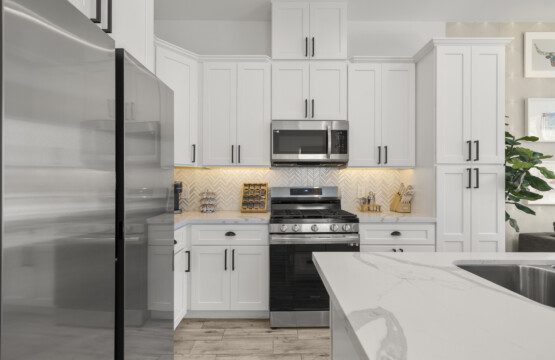 Modern full kitchen with white cabinets and stainless appliances at The Landing Pad Houston vacation rental near NRG Stadium