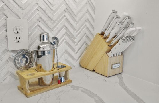 Kitchen counter with cocktail shaker set and knife block at The Landing Pad Houston vacation rental near NRG Stadium