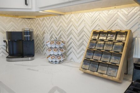 Fully stocked kitchen counter with Keurig coffee maker and spice rack at The Landing Pad Houston vacation rental near NRG Stadium