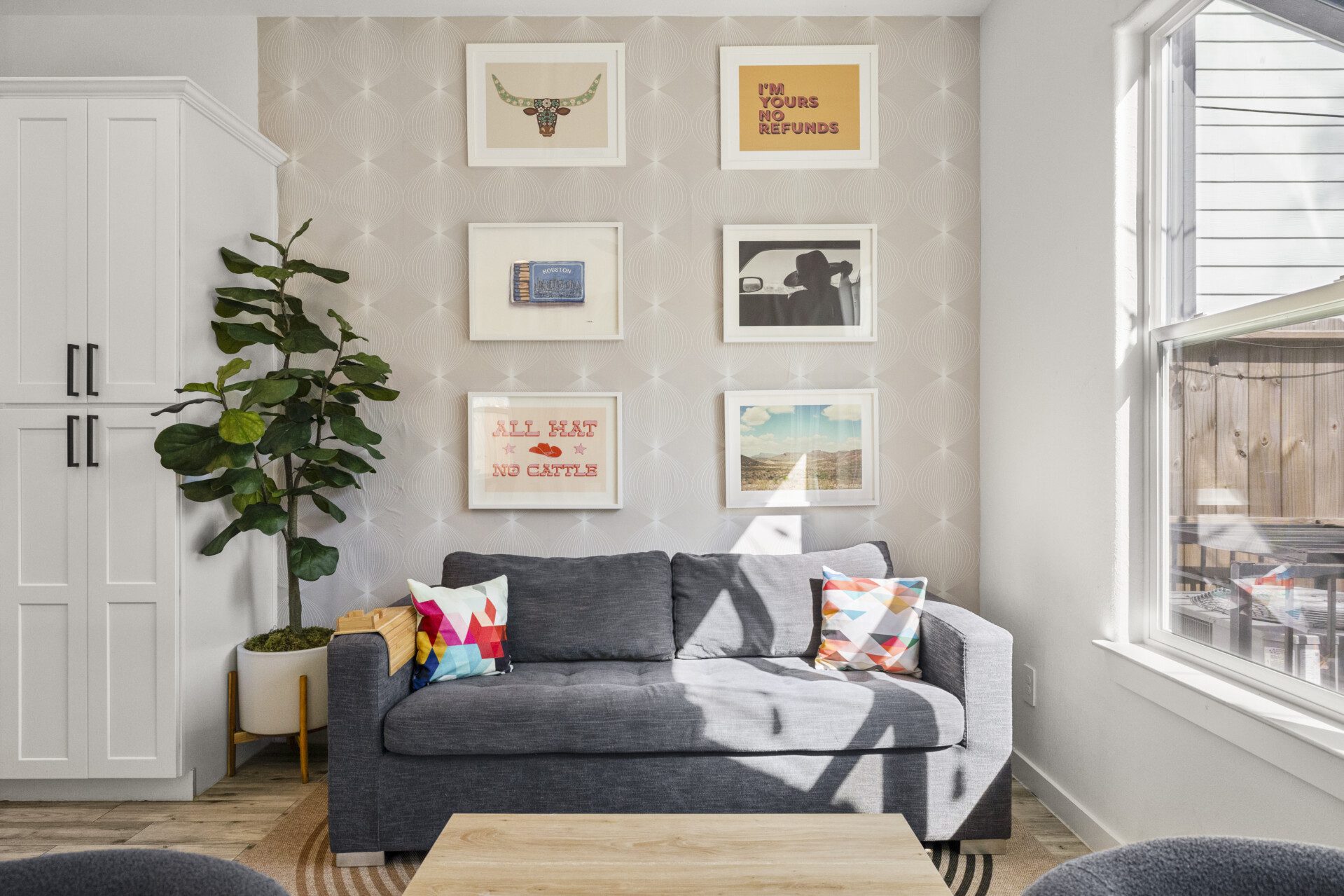 Living room sofa and gallery wall at The Landing Pad Houston vacation rental near NRG Stadium
