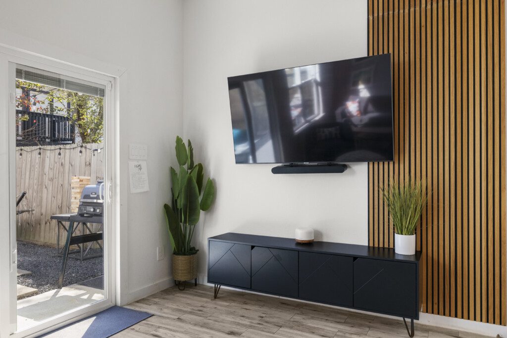 Modern living room with Smart TV and backyard access at The Landing Pad Houston vacation rental near NRG Stadium