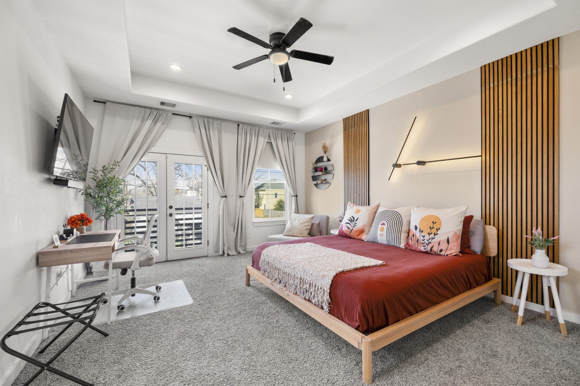 Complete guest bedroom with workspace and French doors at The Landing Pad Houston vacation rental near NRG Stadium