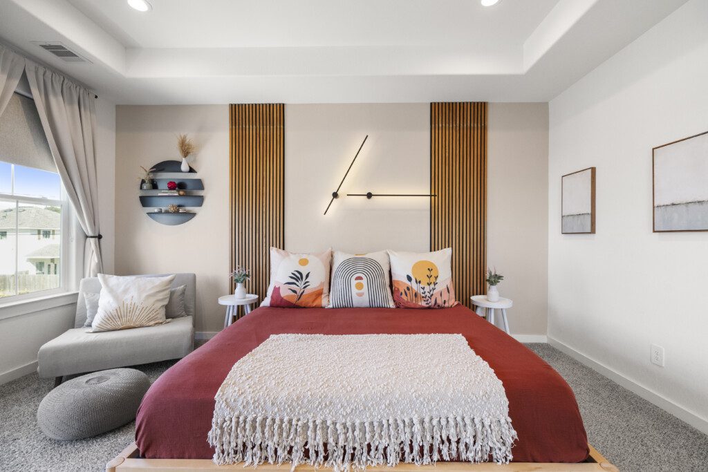 Bright guest bedroom with king bed and window seating at The Landing Pad Houston vacation rental near NRG Stadium