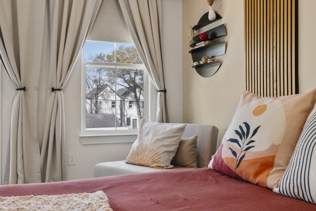Colorful guest bedroom with wood accent wall at The Landing Pad Houston vacation rental near NRG Stadium