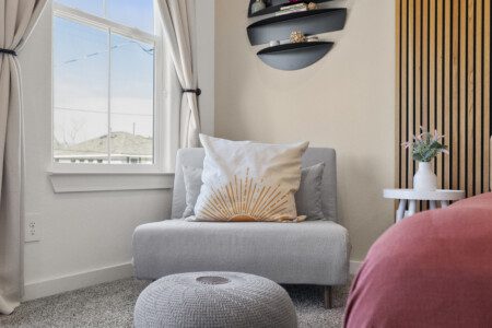 Cozy bedroom seating area with natural light at The Landing Pad Houston vacation rental near NRG Stadium