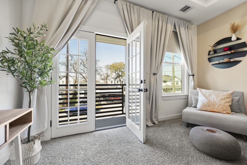 Master bedroom sitting area with French doors to balcony at The Landing Pad Houston vacation rental near NRG Stadium