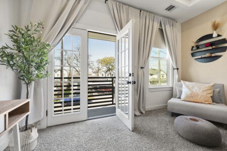 Master bedroom sitting area with French doors to balcony at The Landing Pad Houston vacation rental near NRG Stadium