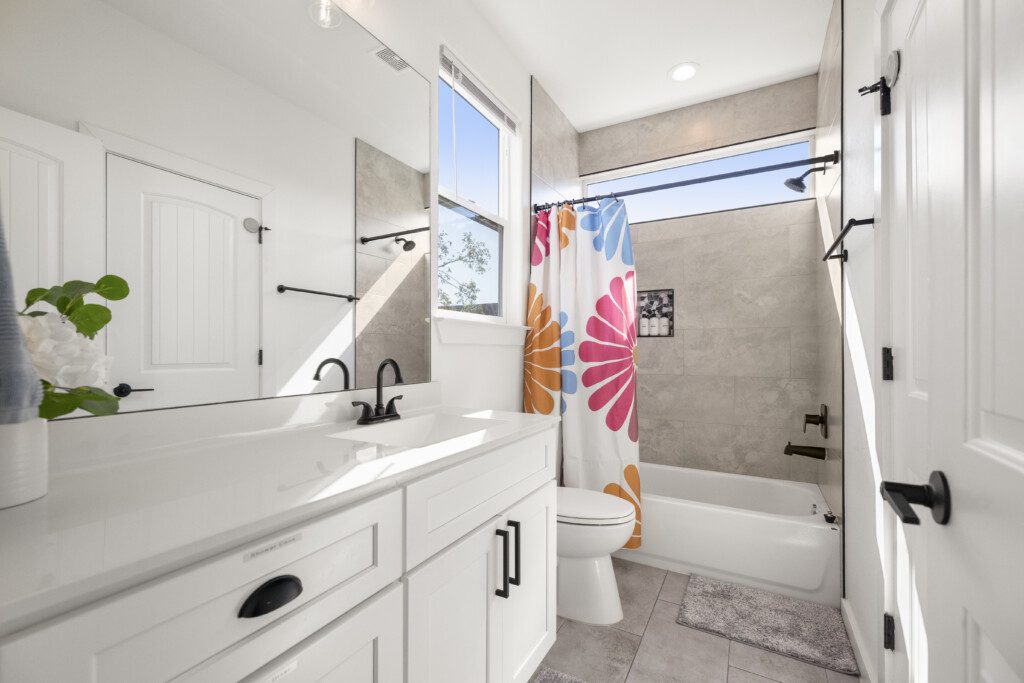 White double vanity bathroom at The Landing Pad Houston vacation rental near NRG Stadium with modern fixtures