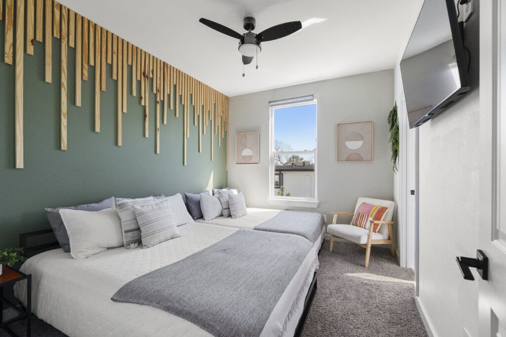 Wide view of guest bedroom with two beds at The Landing Pad Houston vacation rental near NRG Stadium